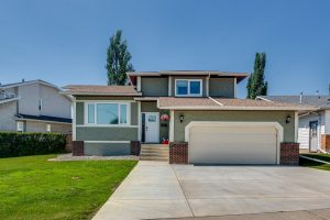 Well-maintained Red Deer home showing clean landscaping and strong curb appeal.